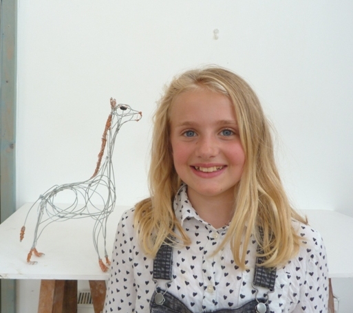 Young artist with wire sculpture